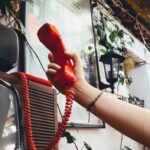 Retro red telephone with coiled cord creating an 80s Stranger Things atmosphere