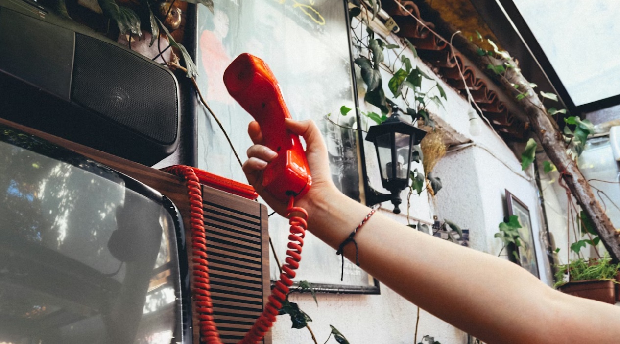 Retro red telephone with coiled cord creating an 80s Stranger Things atmosphere